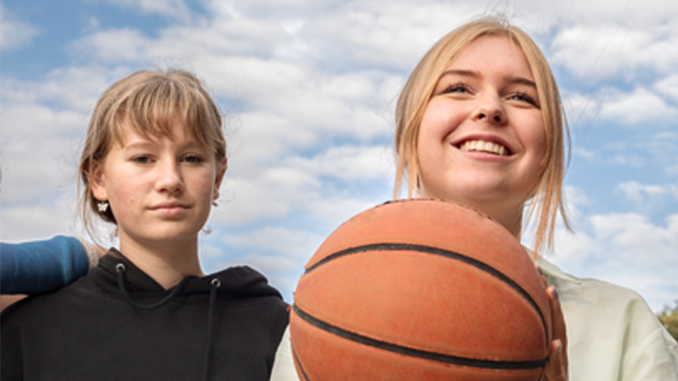 Två tjejer som spelar basket